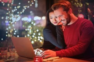 Two happy people looking at a website. Simplified SEO Consulting offers monthly SEO packages for counseling practice owners.