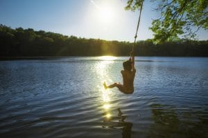 young boy bungee jumping over water. Shows how therapists in private practice can use subtle means to convey they offer Christian Counseling and a Faith Based Practice