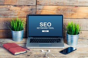 Computer with the words "SEO Keyword Tool." This computer is being used to find the best keywords for mental health professionals in the area. Contact Simplified SEO Consulting for support keyword research tools for therapists and more. 
