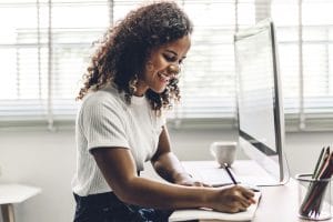 African American woman working on SEO at her computer | SEO consulting | SEO for private practice owners | SEO for therapists | Counseling keywords | Simplified SEO Services