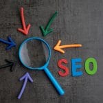 The letters S. E. O. with a magnifying glass and errors pointing to it to show how this post focuses on keyword placement for counseling websites to improve search engine optimization.