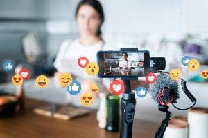 A vlogger uses her camera. This reflects components of boosting web presences through live feed. Learn more with SEO Consulting. 