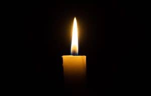 A lit white candle on a black background. Symbol of eternal memory, mourning, minutes of silence. Is SEO dead? Learn from an SEO expert for therapist websites and other helping professionals. 
