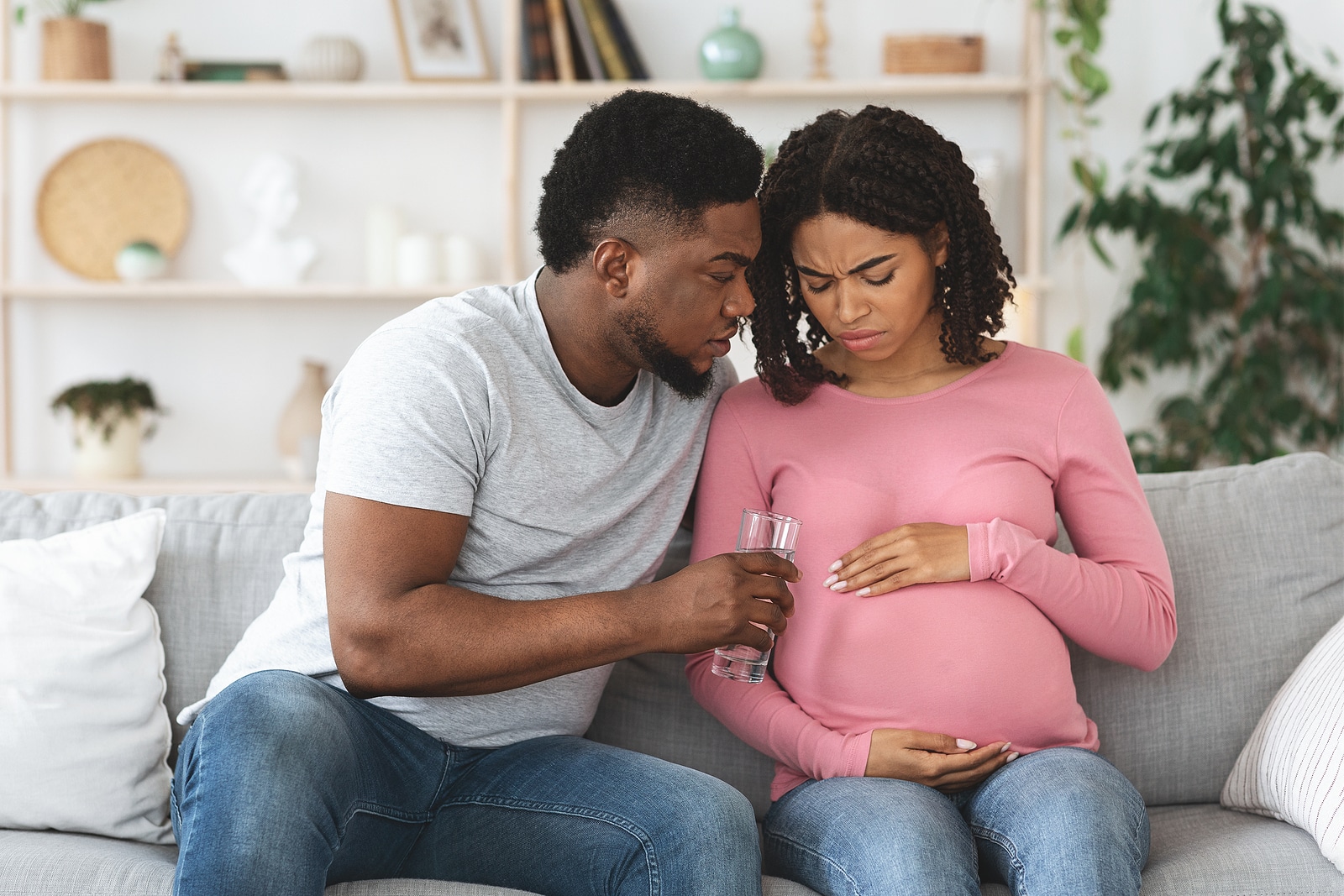 Care, support in couple during pregnancy. Black expecting wife feeling sick, husband giving her glass of water, home interior, free space. African american man supporting his woman during pregnancy. We help boost SEO for birth workers including doulas, midwives, postpartum therapists, postpartum support, prenatal yoga instructors, childbirth educators, lactation consultants, placenta encapsulation professionals and more.