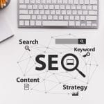 Top down perspective of SEO graphic next to a keyboard. Understanding SEO can be a hard task, but we can help. Simplified SEO Consulting offers seo help for therapists.