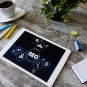 Table in wooden table near coffee and plant. SEO for mental health professionals is very important to get your people, but ethical seo is a must. Learn how optimizing SEO for backlinking can help you build credible traffic to your website.