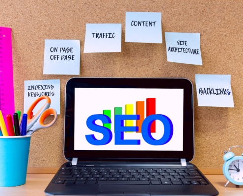 computer with the text SEO with seo keywords around it. Learn about optimizing your website from an seo specialist