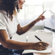 Image of a woman sitting at a desk representing the search for deal clients through simplified. | How to Build SEO for Therapists, How to rank on Google for Therapists, Is SEO Good for Therapists |