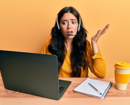 Shows a confused woman at a computer. Represents how duplicate content can affect SEO negatively