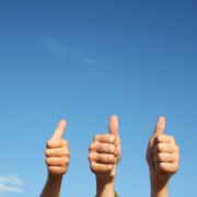Image of five hands holding a "thumbs up" against a blue sky background. This image represents the good SEO for psychiatrists that happens when they work on getting backlinks.