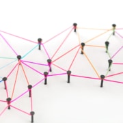 yarn linking pins together like a web. Represents how links can help boost your SEO and direct your audiences attention