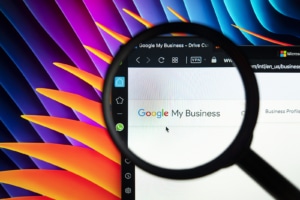 A close up image of a magnifying glass looking at the text Google My Business. Contact Simplified SEO Consulting for support with local SEO for therapists and other services. We can help your private practice website thrive!