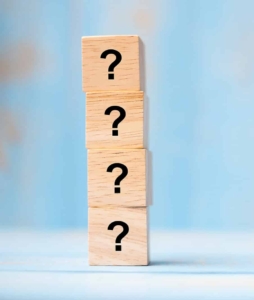 Four blocks with question marks on them showing how answering FAQs can be great for blog post topics. Generate a list of common questions your clients or patients ask and answer those in blog post form to grow your private practice!