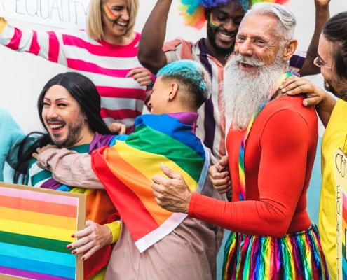 Happy people wearing gay pride flags celebrating the improvement of SEO keywords