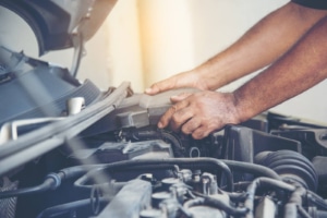 Image if a mechanic working on a car engine. SEO tune ups are good for basic maintenance on your site. Original search engine optimization sets a good foundation but tune ups are important. Especially on private practice SEO.