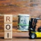 Photo of a toy car holding a roll of bills next to the word "ROI". This photo represents how seo coaching can help therapists learn seo marketing and get a great ROI.