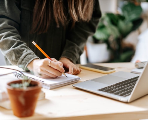 Image of a woman writing on a notepad while looking at a laptop. Are you creating a private practice website in Arkansas? Maybe looking for SEO training for therapists in the United States? We can help you get started finding your mental health SEO keywords. It all starts by contacting us today!
