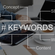 Photo of a desk with the word "keywords" in the middle and related words around representing the importance of keyword research in working on SEO