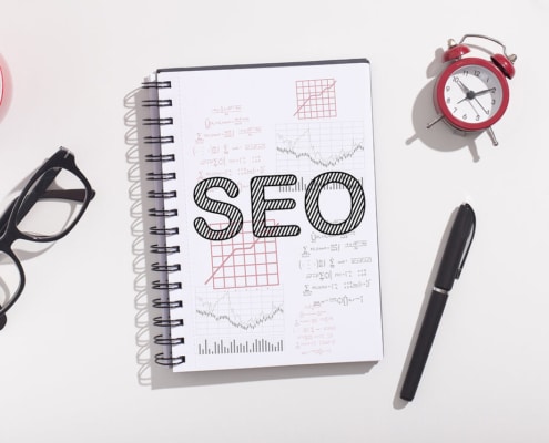 A book with SEO written on it on a table. Looking to improve your healthcare SEO but don't know where to start? Our SEO strategy for the healthcare industry can help!