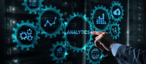 A hand points to a graphic that reads “analytics”, surrounded by technical symbols. Learn how to rank on google for therapists by contacting Simplified SEO Consulting. We offer seo services for therapists and other services.