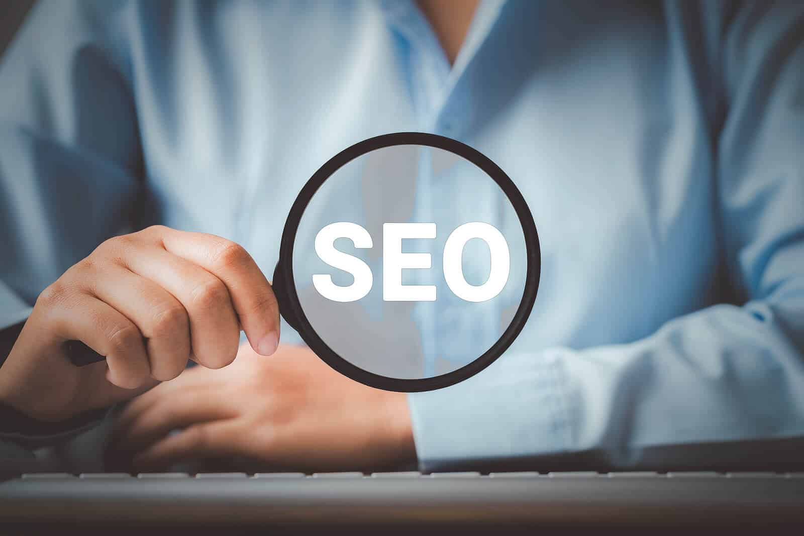 Person holding a magnifying glass with "SEO" in the glass. You can get custom SEO services for therapists and private practice websites with our mental health SEO experts for SEO copywriting and higher rankings on Google and other search engines.