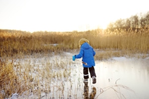 Photo of a child on a frozen lake representing how a Canadian therapist might carefully choose a hopeful photo such as this one as part of their on page optimization plan. Carefully choosing & optimizing photos is a great on-page SEO strategy.