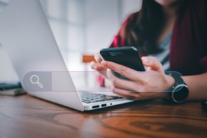 Image of a person looking at a phone and a computer representing the clients and help you could get from Simplified SEO Consulting. We help with SEO for Therapists! 