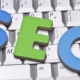 The letters SEO in blue and green laying on a keyboard. Want to learn how to use SEO tools for your business? Our team of SEO specialists can teach you SEO basics.