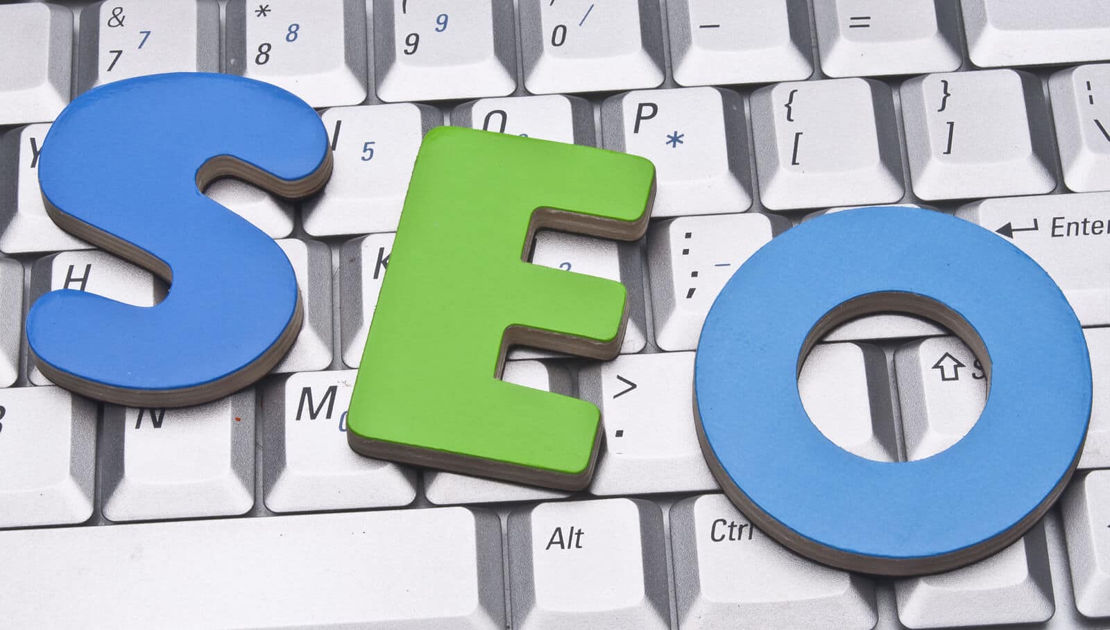 Blue and Green SEO words laying on top of a keyboard. Looking to learn about local SEO for doctors? Our specialists can teach you all you need to know about SEO in healthcare. 