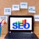 Shows a computer with the word "SEO" with components of it on sticky notes. Represents how seo for private practices can improve with SEO friendly content.
