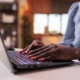 Photo from Bigstock of an African American female's hands on a computer representing a private practice owner who wants their speech therapy practice to rank well on Google and improve their SEO without blogging.