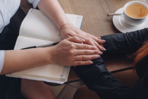 A close up of a person offering their hand in support to another. Learn more about the best therapist directories by searching for "therapist directory" today.  
