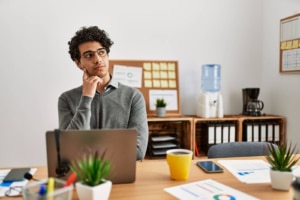 Shows a man looking confused at his desk. Represents a therapist thinking "how to rank on google for therapists". Search "local seo for therapists" to learn more!
