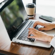 Woman typing on a laptop to create content for her private practice. Improve your Private practice SEO with ways to create content and begin using easy language for users to read without professional jargon.