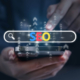 Image of a phone with a search bar and the word seo typed in. Wondering what SEO is? Learn here what SEO is and how private practice SEO can help your website!