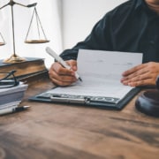 A scale of justice sitting on a desk. Curious to know the best law firm marketing strategies? Learn more here!