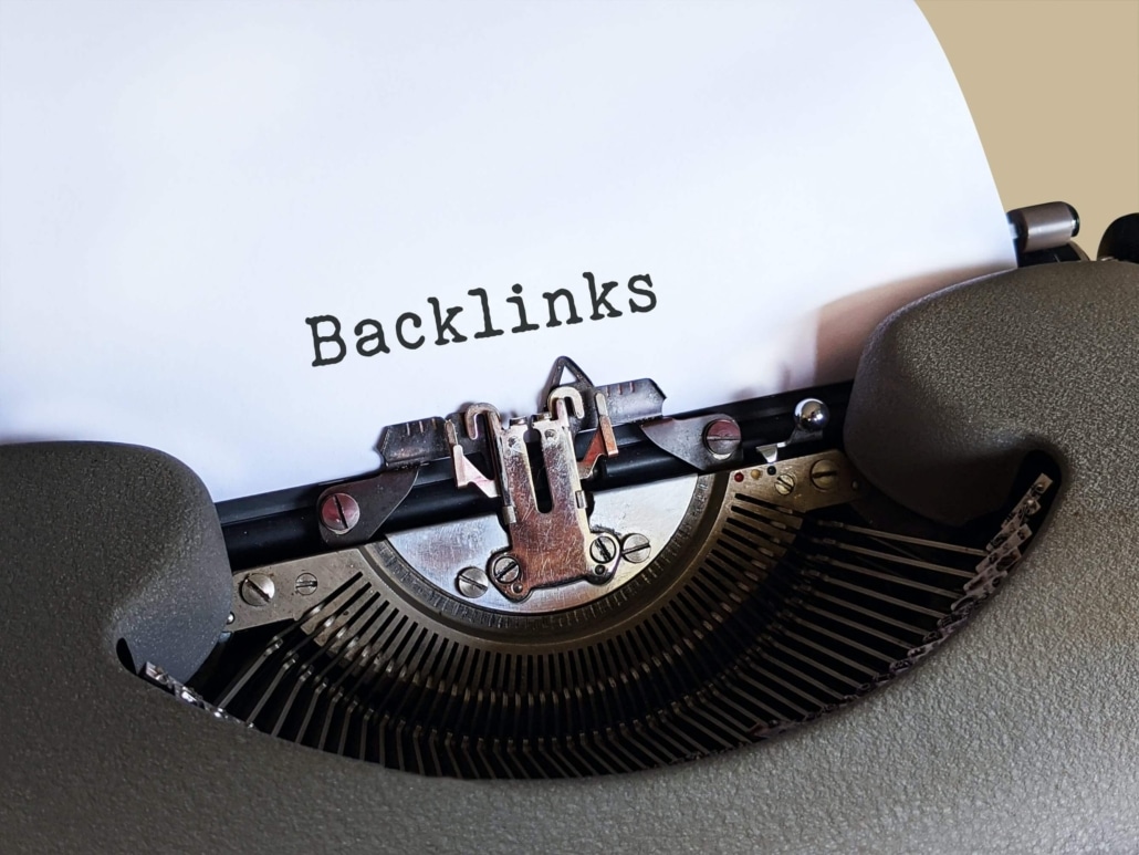 A type writer that has the word "backlinks" typed on a piece of paper representing the importance of backlinks for SEO Services. Work with an SEO Specialist in Missouri to learn more.