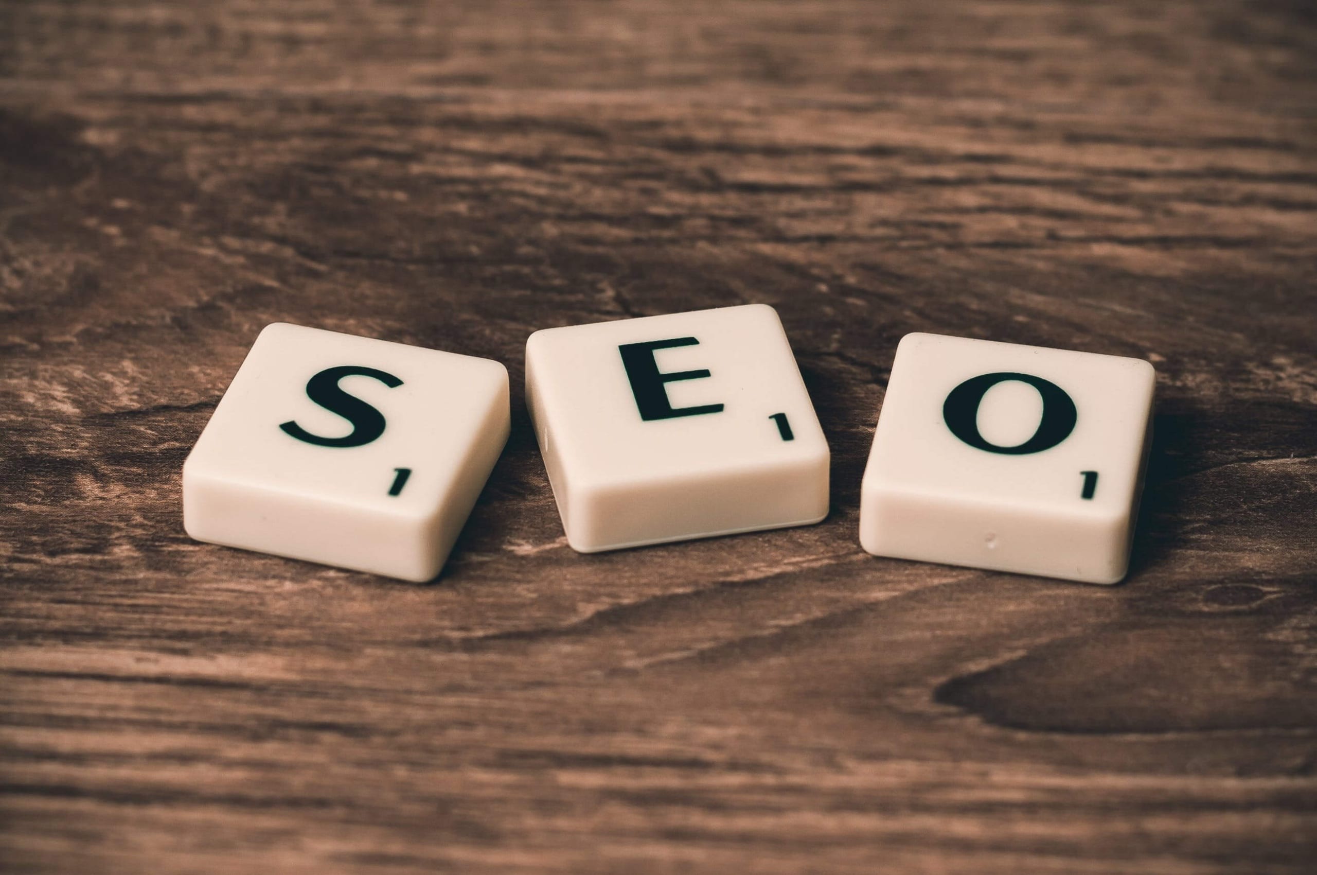 Image of tile letters on a wood table spelling out SEO. Discover how SEO for private practice owners can help establish your business find your ideal clients.