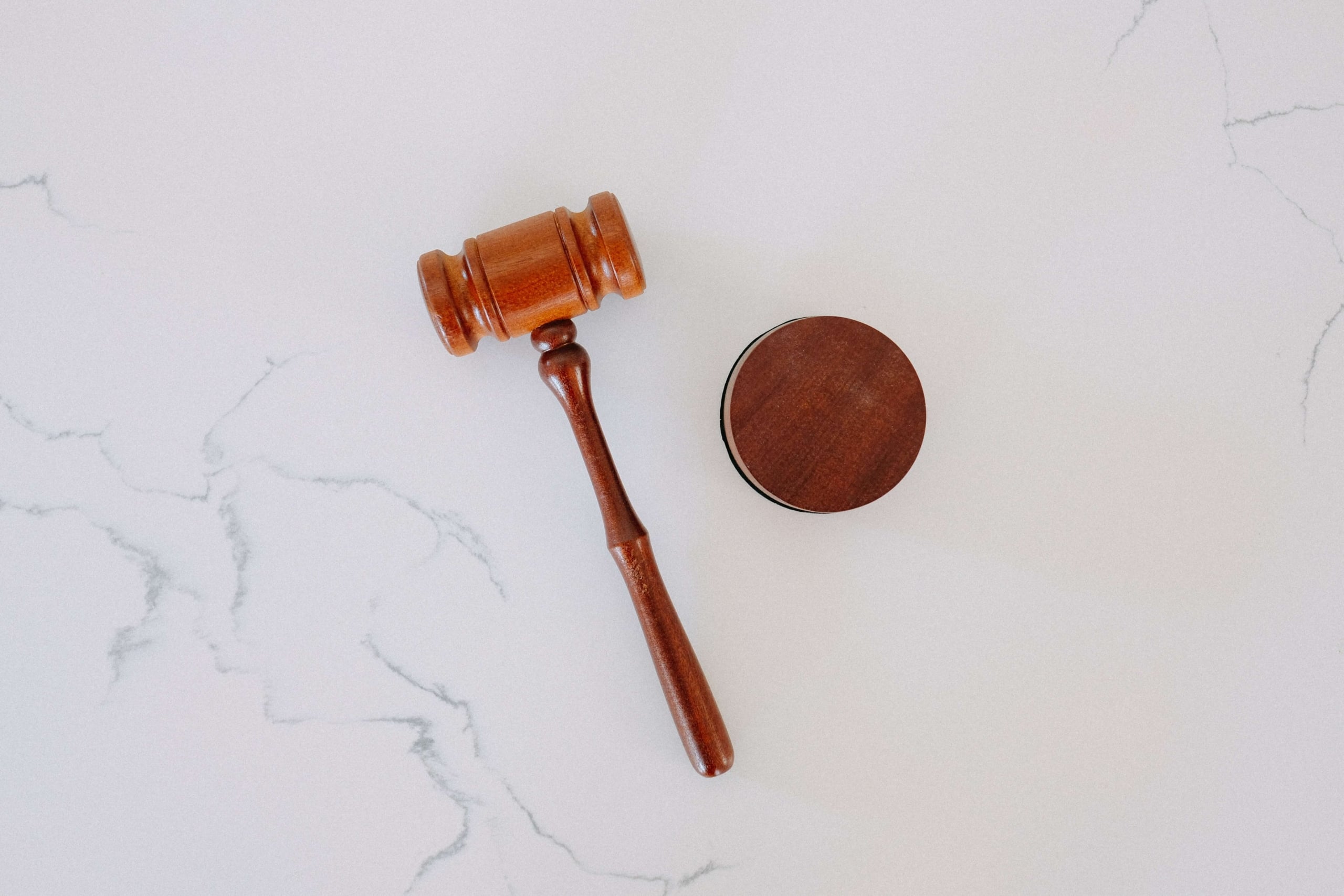 Image of a gavel laying on a marble counter. Learn how to advertise your law firm with the help of SEO.