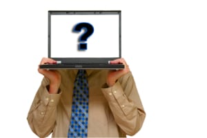 business man holding a laptop with a question mark. Search for seo for mental health professionals and how SEO for online counseling pages can help.