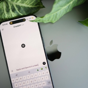 Shows an iPhone with ChatGPT pulled up and the phone is on an Apple laptop. Represents how free copywriting ai tools can help with private practice SEO but may not be needed.