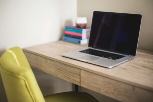 A laptop sitting on a work desk. Want to learn more about SEO for therapists? Contact us today for a free consultation! 