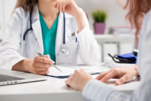 Doctor discussing treatment with patient while using local SEO for doctors to improve online visibility for medical practices. 