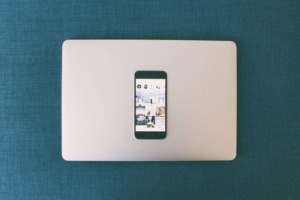 An Iphone resting on top of a macbook. SEO marketing is different than social media. But what's better? Explore our blog.
