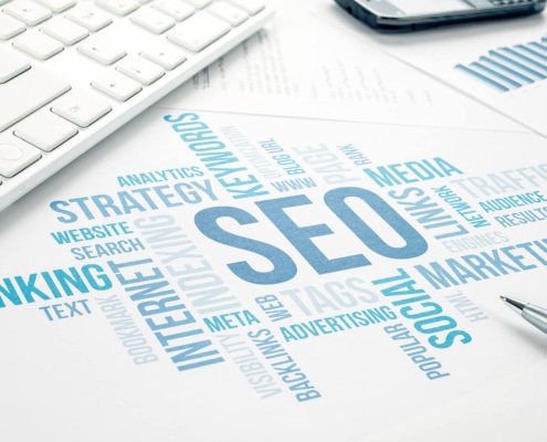 A word cloud highlights SEO, ranking, and marketing with a keyboard nearby. Curious about SEO for holistic health and wellbeing? A trusted medical practices SEO consultant can guide you in boosting visibility and connecting with more ideal clients.