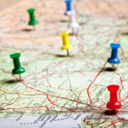 A paper map with colorful pushpins marking locations, representing how Local SEO for doctors and Local SEO for medical professionals improves visibility. An essential part of Local SEO doctors marketing is helping patients find clinics in their area.