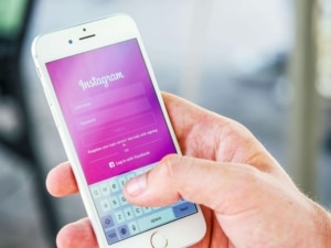 An iphone with "Instagram" on the purple screen. A social media specialist can enhance SEO efforts & help ideal clients find you. Reach out today for a free consultation. 