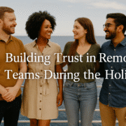 A group of coworkers smiling together on a cruise ship, representing how remote team trust building and small business leadership create genuine connection during the holidays. California, Kansas, Maryland, United States.