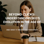 Therapist professional working on a laptop in a warm, neutral office, symbolizing how SEO for Therapists now blends traditional search with AEO and GEO in the AI era.