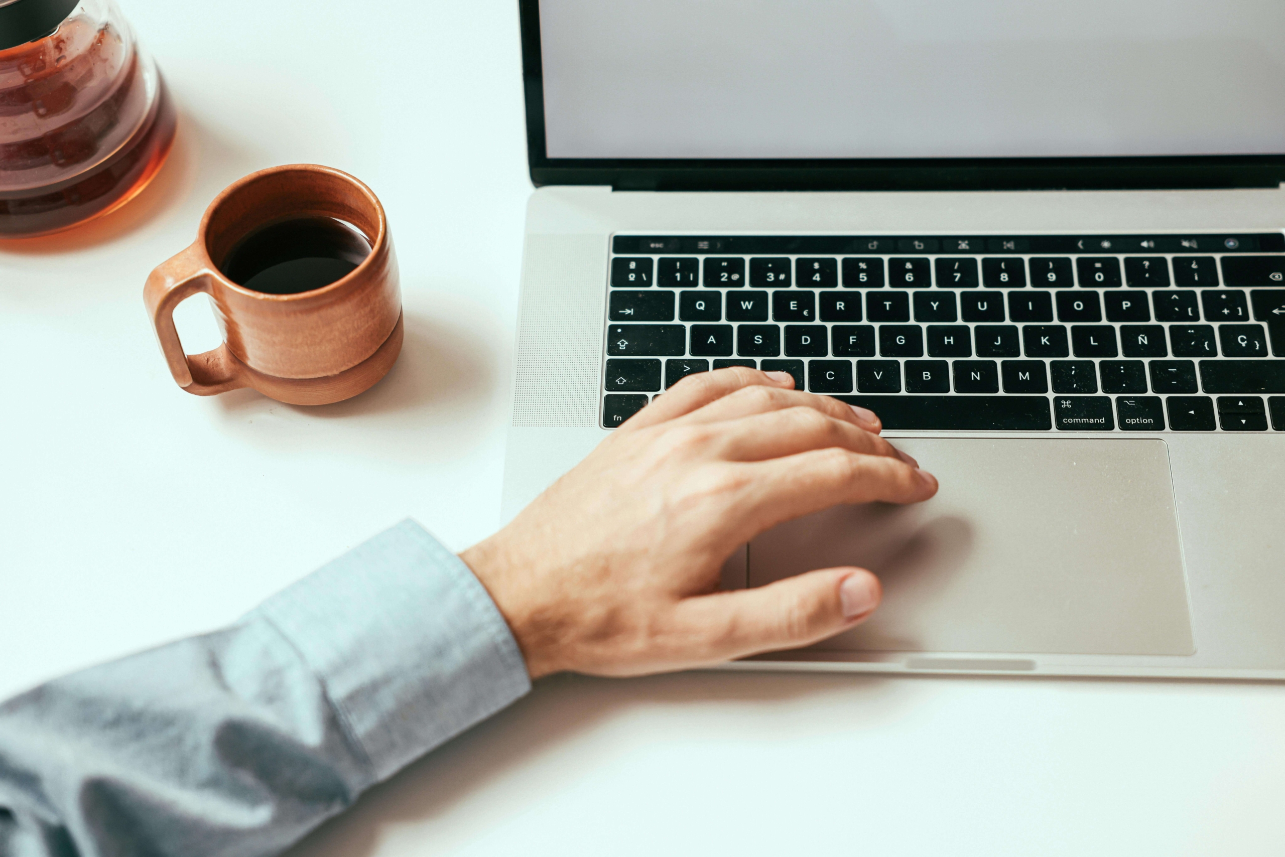 A practitioner using a laptop to work on their website, emphasizing the role of alternative healing SEO in improving visibility for wellness services.